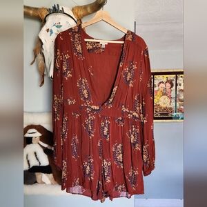 Long-sleeved romper w/ deep v-neck